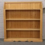 A carved pine bookcase, 132cm wide x 138cm high.