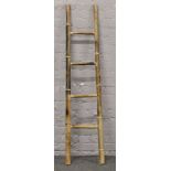A small four rung bamboo ladder.