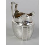 A George III Irish silver cream jug with reeded figure 7 handle and chased with stylised bands,