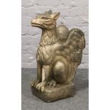 A gilt painted cast concrete garden griffin, 65cm tall.