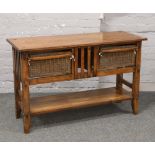 A hardwood kitchen side table fitted with two basket drawers.