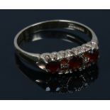 A 9ct gold seven stone garnet ring in a boat shaped setting. Size P.