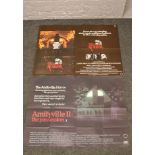 Two film advertising posters The Amityville Horror and Amityville II The Possession both printed