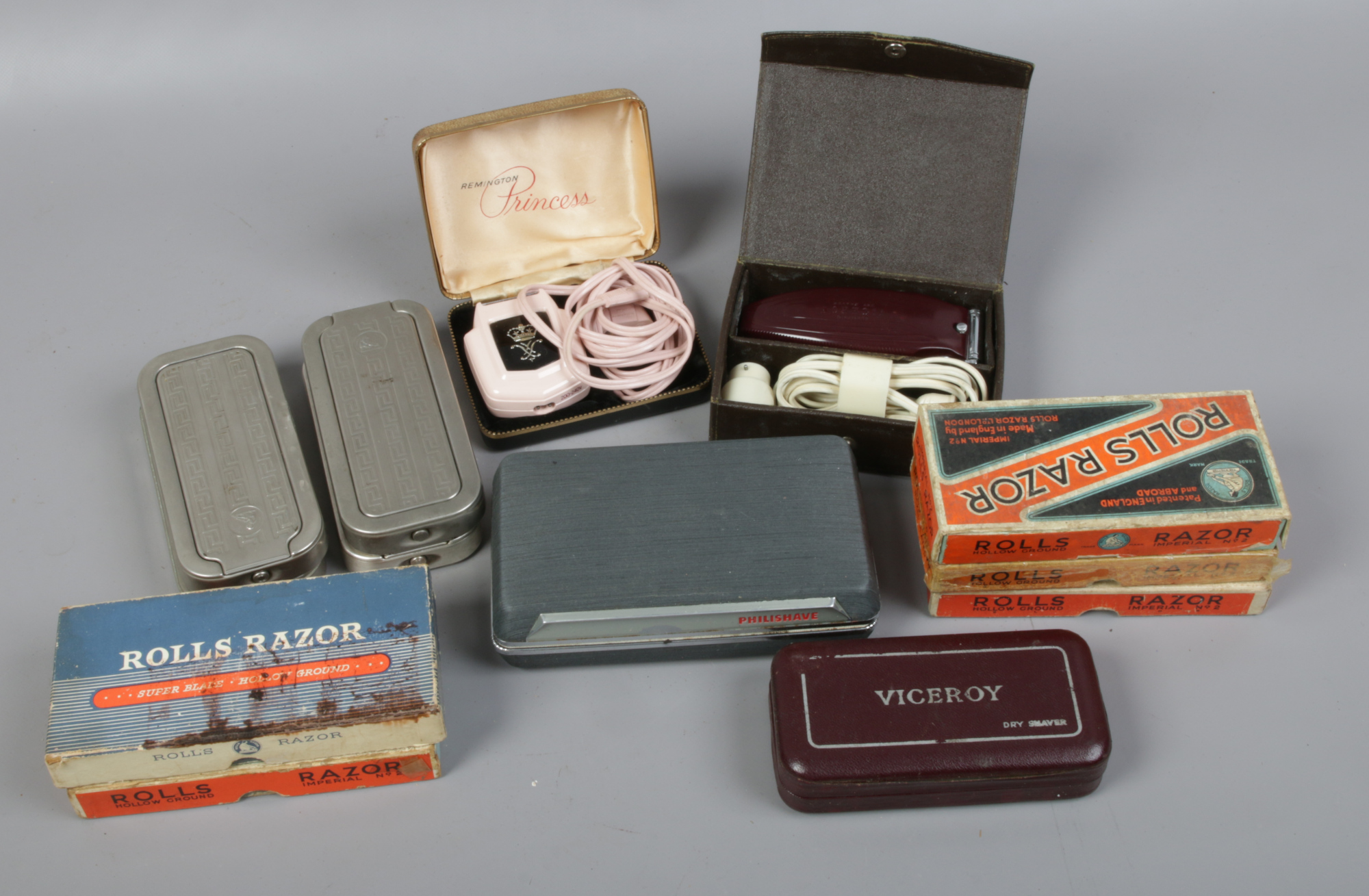 A collection of Rolls razors including boxed examples and various cased vintage electric razors