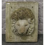 A concrete lion mask wall mounting water feature.