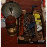 A box of miscellaneous tools, boxed portable fans and two Tilley lamps.