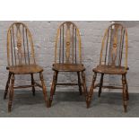 Three spindle back dining chairs.Condition report intended as a guide only.Split seat bases.