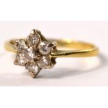 Vintage 18ct gold ring with 7 diamond flower head design size P/N. Gross weight: 2.3g (with ring