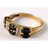 9ct gold ring set with 6 octagon cut sapphires and 4 diamond spacers. Size P. Gross weight: 3g