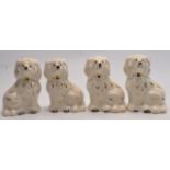 Four mantle dogs with gilt highlights