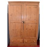 Vintage pine wardrobe with inset panel doors above two short drawers