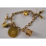 9 Carat gold charm bracelet to include 6 charms and a mounted quarter Kruggerand (POND)