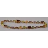 A 14ct gold peridot and topaz ladies bracelet