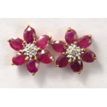 Pair of 9k yellow gold stud ruby earrings with diamond setting
