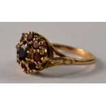 A 9ct gold floral garnet cluster set ring, with 9 garnets size O