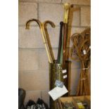 Various Walking Sticks in Brass Holder