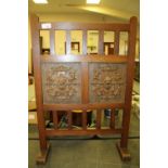 Arts & Crafts oak fire screen with carved lion head masks