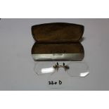 Early 20th Century aluminium spectacles case, stamped Pat. 9.09 and a pair of pince nez spectacles