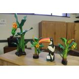 Box of carved wooden plants and toucan