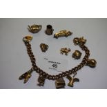 9ct gold and yellow metal charm bracelet 35.7g