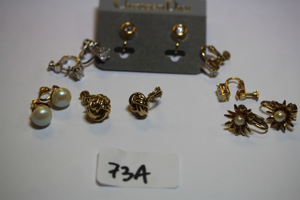 Quantity of clip on earrings, including Christian Dior