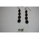 Pair of white metal and black agate graduated four drop earrings