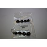Pair of white metal and black agate graduated four drop earrings
