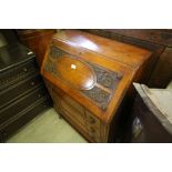 Carved oak bureau