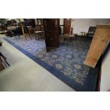 Massive English machine-made carpet of 'Sheraton' design, with repeating oval swags on blue