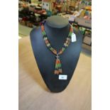 Indian silver and multi gemstone necklace on stand