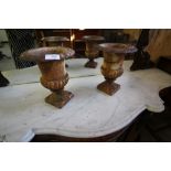 2 small cast iron urns