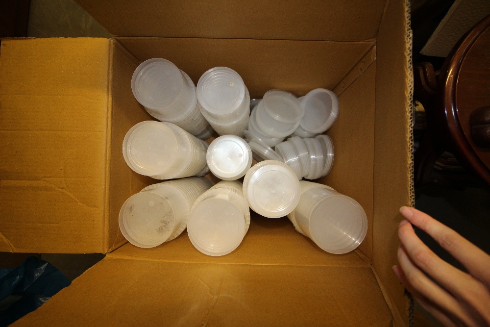 Box of plastic lids and cups