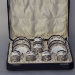 Set of six late Victorian silver mounted Cauldon bone china coffee cans and saucers with floral