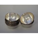 Set of eight Middle Eastern white metal finger bowls, with engraved interiors, each 10.5cm