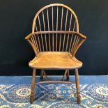 Early 19th Century elm Windsor armchair, with shepherd's crook arms, shaped seat and concave