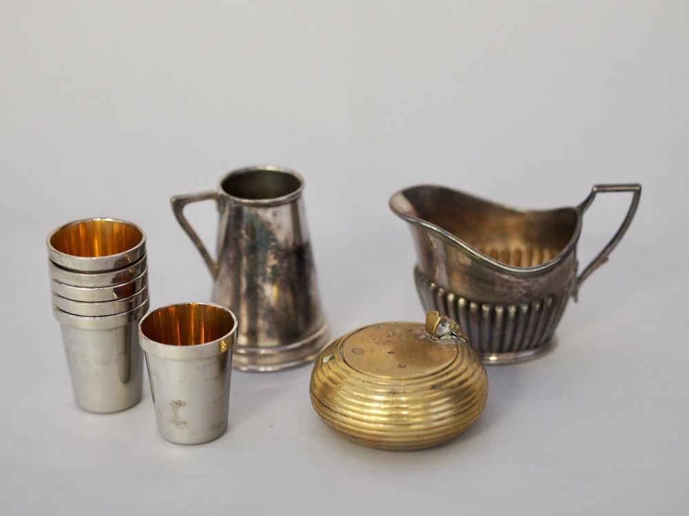 Brass portable ashtray, set six German white metal shot cups, plated cream jug and plated