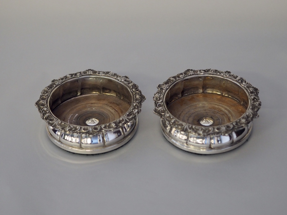 Pair late 19th Century plated wine coasters, with leaf cast rims, internal bosses with eagle