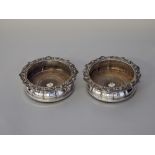 Pair late 19th Century plated wine coasters, with leaf cast rims, internal bosses with eagle