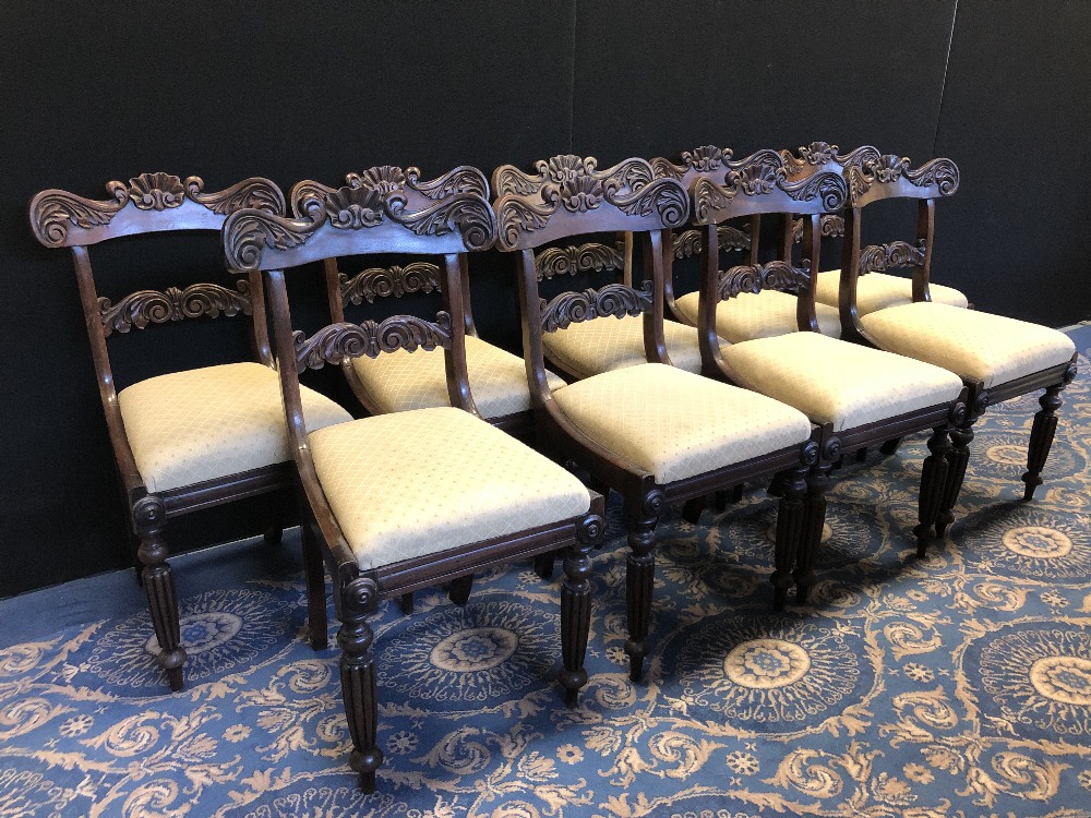 Set of nine Regency rosewood dining chairs, with shaped and moulded crest rails, drop in seats