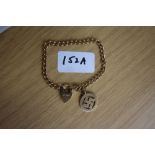 9ct gold bracelet with heart shaped padlock clasp and swastika charm, 11.6grams