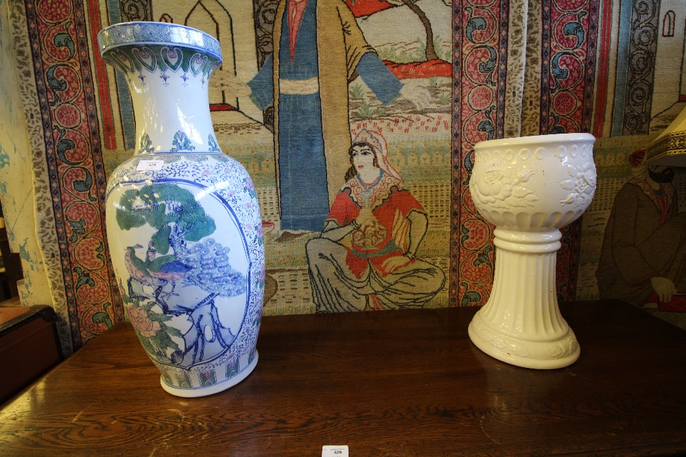 Large vase and white jardinière and stand