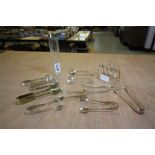 Silver 4 division toast rack, 10 pairs of plated sugar tongs and dressing table jar