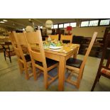 Light wood extending dining table and six chairs