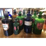 Twelve late Victorian/early 20th Century coloured glass Medicine bottles, some lacking/with