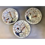 Three 19th Century Derby Imari porcelain plates, decorated with Japanese inspired trees and birds,