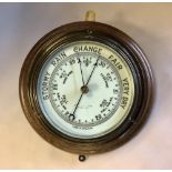Victorian lacquered brass cased aneroid barometer, on oak mount, 27cm diameter (wear to dial)