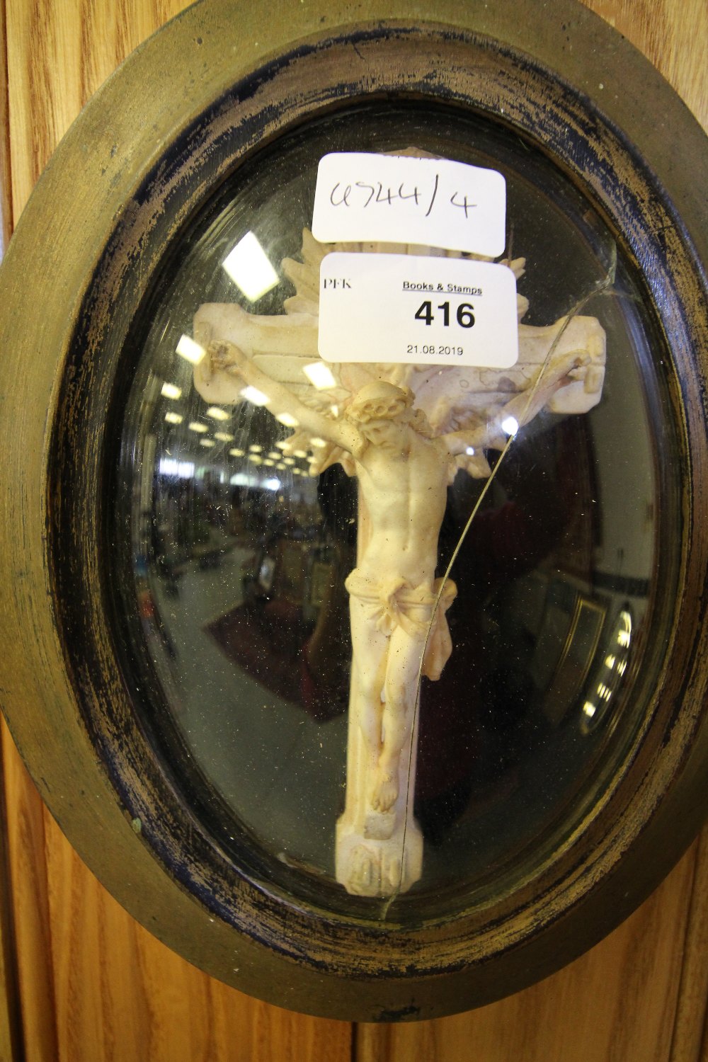 Plaster cross in oval frame