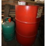 Drum of red diesel oil and gas bottle