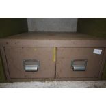 Metal two drawer cabinet containing electrical sockets and switches