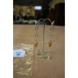 Pair of modern silver and amber pendant earrings